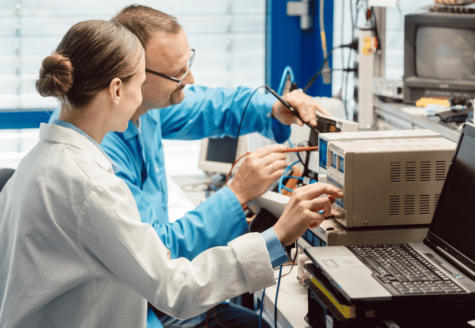 High-tech engineers testing electronic equipment in a laboratory environment.
