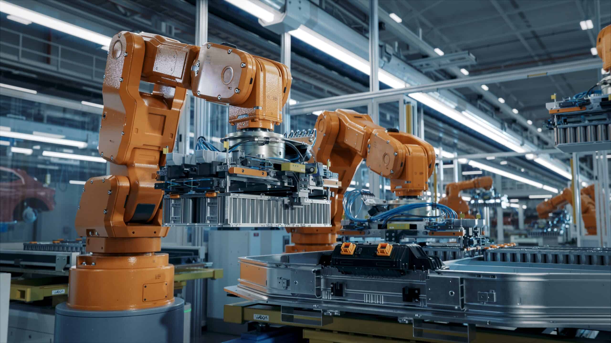 Robotic arms in a high-tech industrial manufacturing plant, showcasing automation and advanced robotics technology.