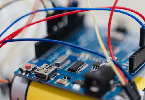 Macro photo of a little embedded systems motherboard with attached cables